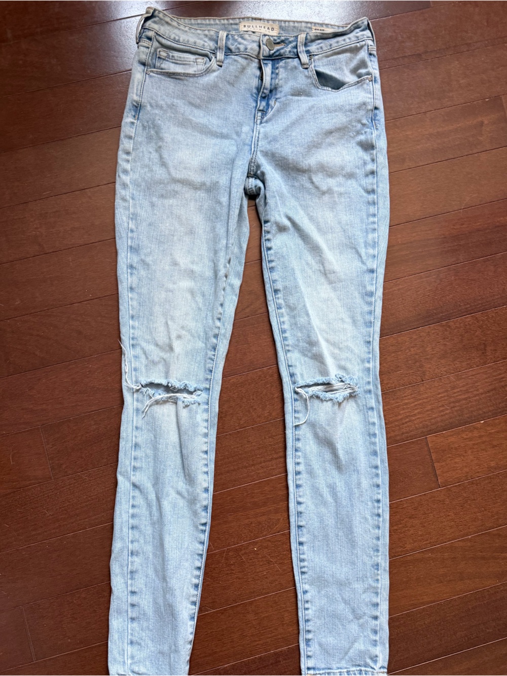 Bullhead Denim Co. light wash distressed jeans
Size 27 Long